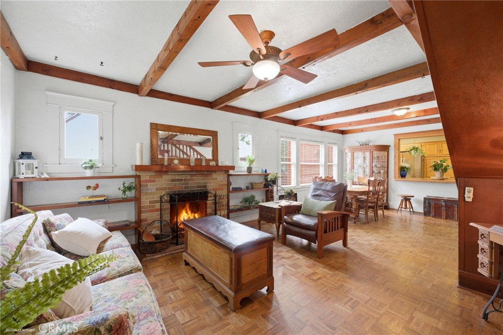 4456 12th Street Riverside, CA 92501 - Photo 6 of 70 a living room with furniture a fireplace and a chandelier