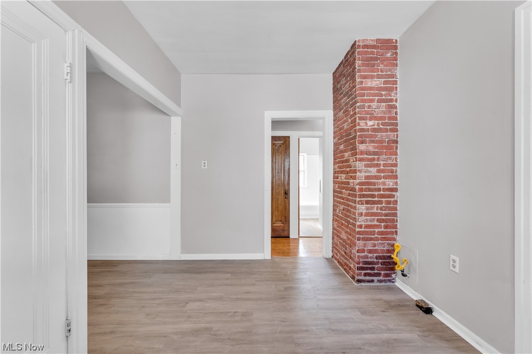 1499 Sherbrook Road South Euclid, OH 44121 - Photo 15 of 41 Unfurnished room with brick wall and light hardwood flooring