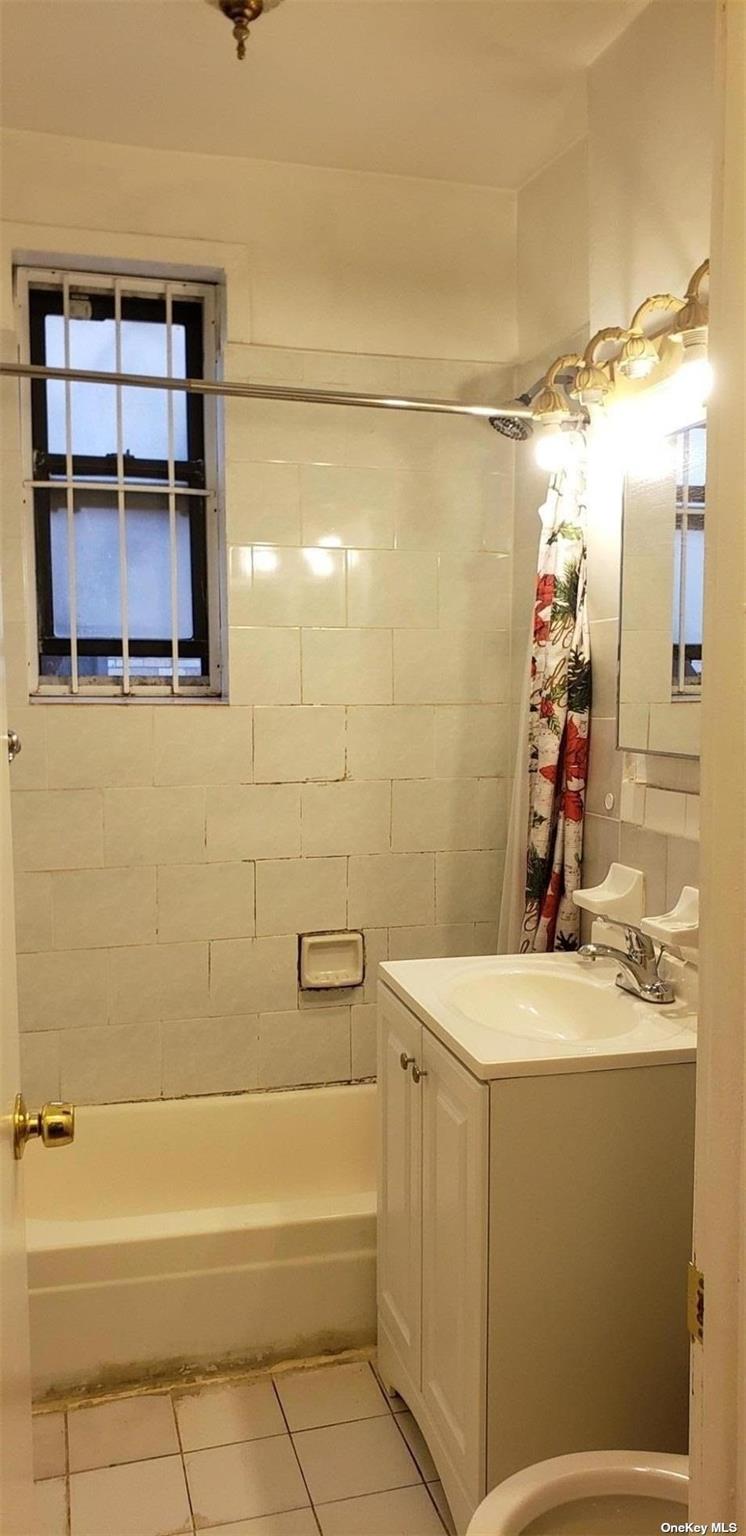 44-15 43rd Avenue, Unit 5N Queens, NY 11104 - Photo 11 of 11 a bathroom with a sink a vanity and a shower