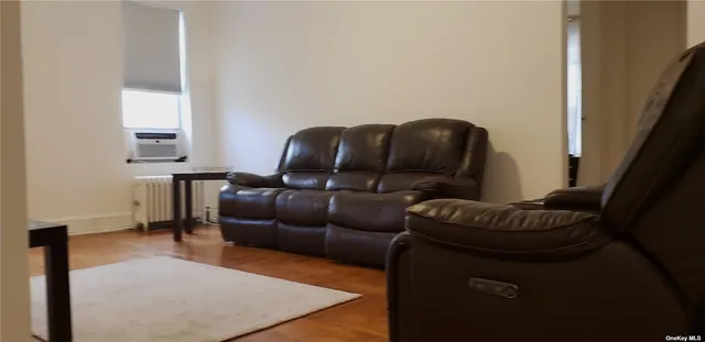 a living room with furniture and a mirror