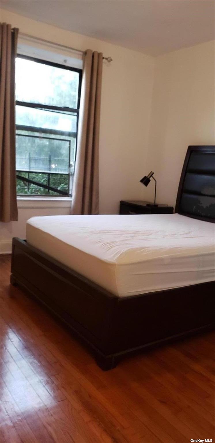 44-15 43rd Avenue, Unit 5N Queens, NY 11104 - Photo 7 of 11 a bedroom with a bed and a window