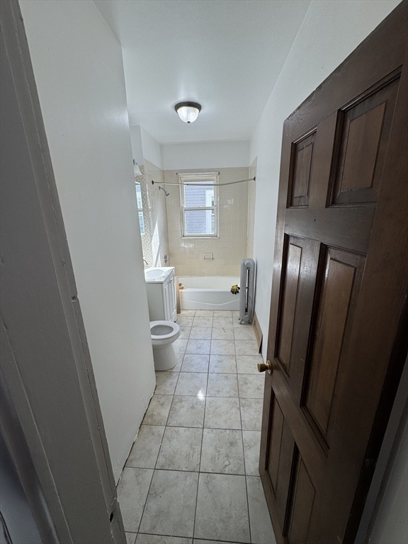 3 Ballou Avenue, Unit 3 Boston, MA 02124 - Photo 2 of 6 a bathroom with a sink a toilet and a shower