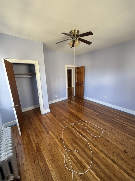 3 Ballou Avenue, Unit 3 Boston, MA 02124 - Photo 3 of 6 a view of an empty room with wooden floor and a window