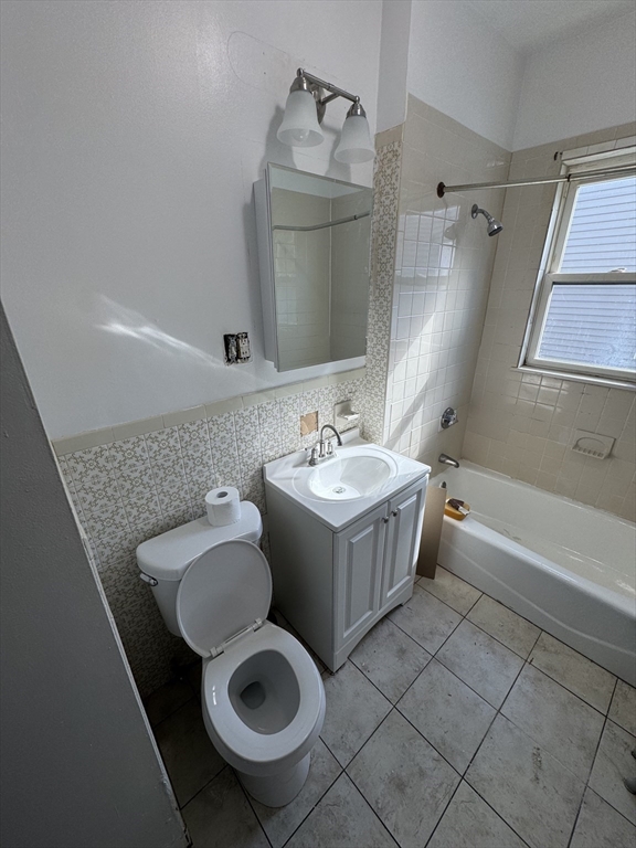 3 Ballou Avenue, Unit 3 Boston, MA 02124 - Photo 4 of 6 a bathroom with a sink toilet and shower