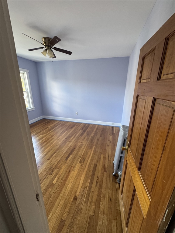 3 Ballou Avenue, Unit 3 Boston, MA 02124 - Photo 6 of 6 a view of a room with wooden floor and staircase