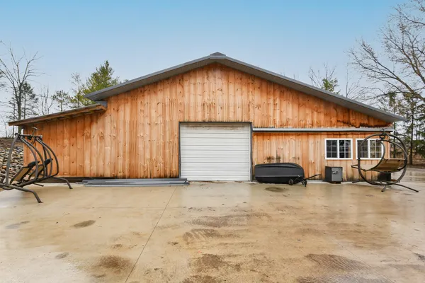 a dining hall with stainless steel appliances granite countertop a stove and a wooden floors