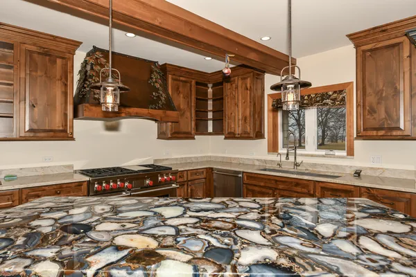 a kitchen with stainless steel appliances granite countertop a stove and a microwave