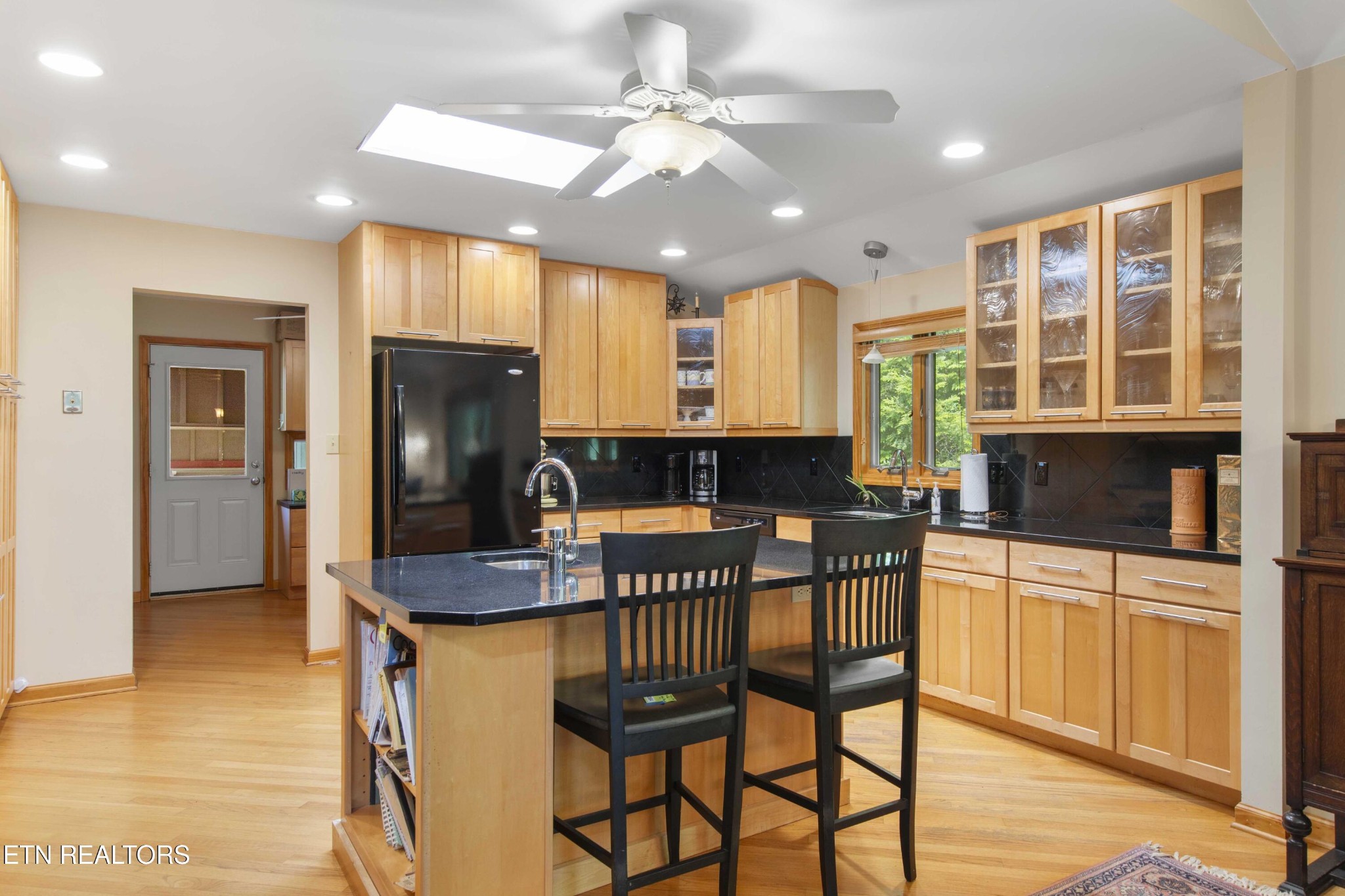 780 Old Emory Road Clinton, TN 37716 - Photo 14 of 33 a kitchen with stainless steel appliances granite countertop a stove a refrigerator a microwave oven with a dining table and chairs