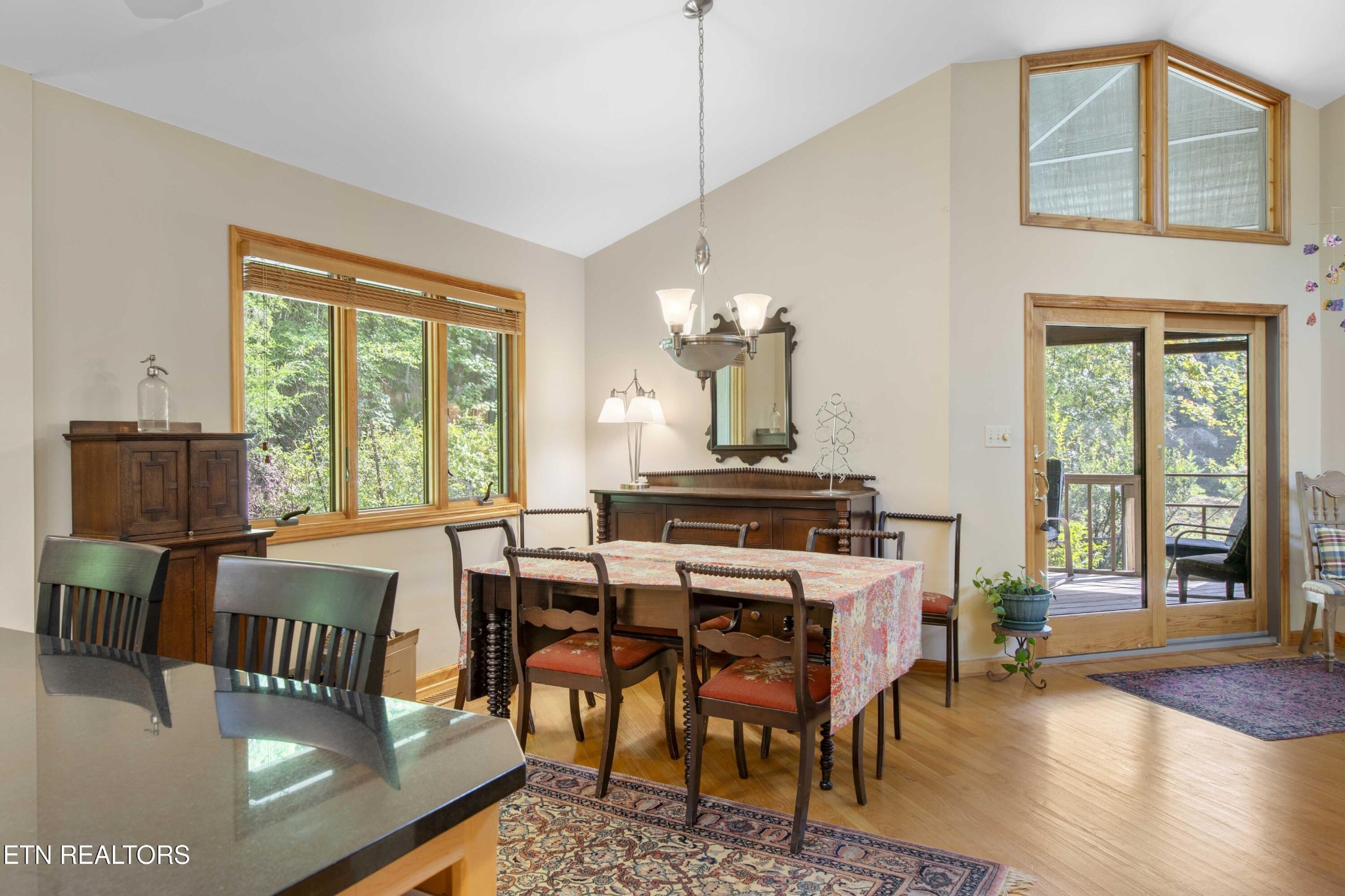 780 Old Emory Road Clinton, TN 37716 - Photo 20 of 33 a dining room with furniture a chandelier and wooden floor