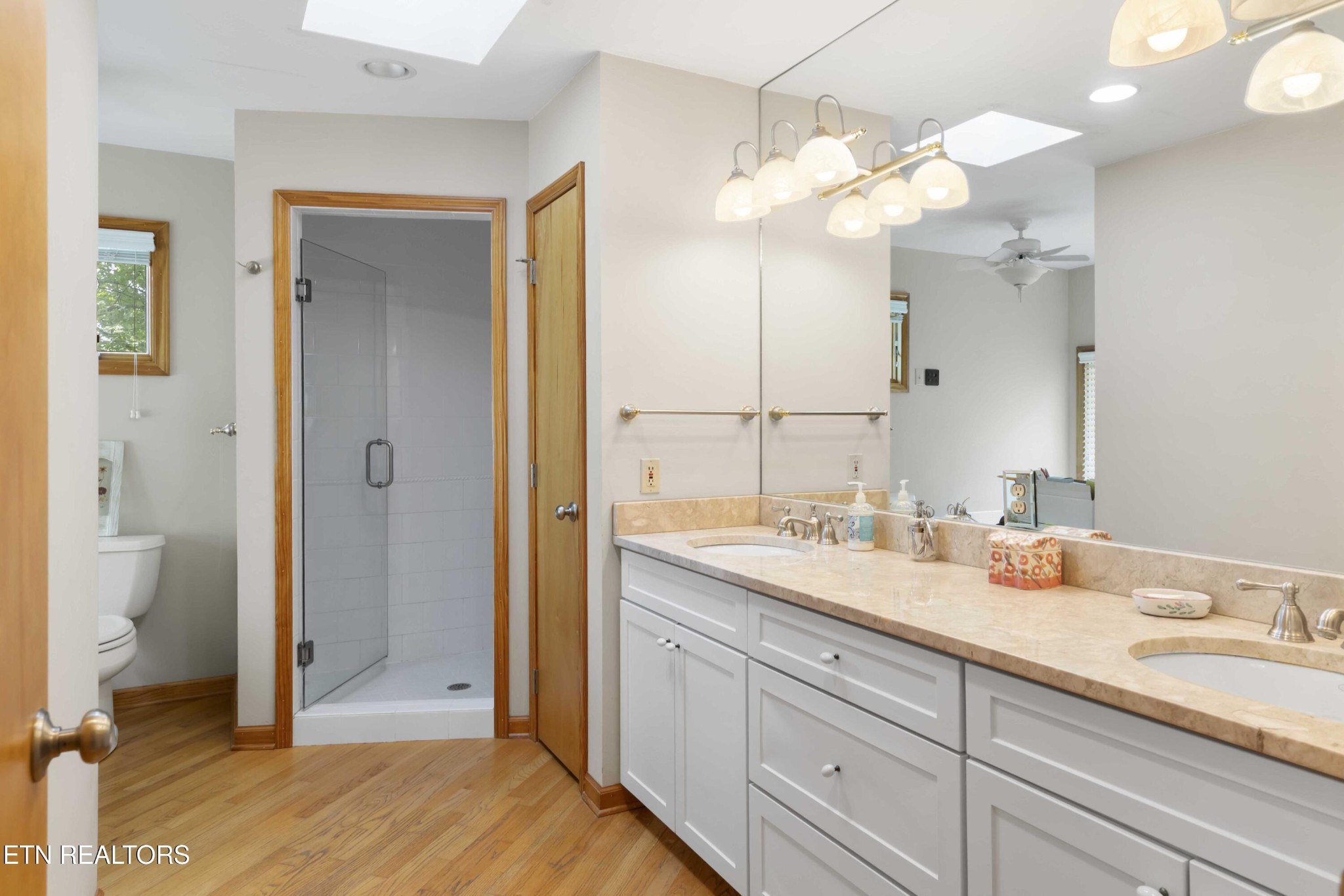 780 Old Emory Road Clinton, TN 37716 - Photo 33 of 33 a spacious bathroom with a granite countertop sink a mirror and a shower