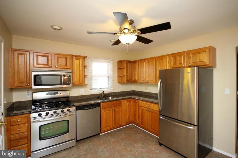 9125 Santa Rita Road Baltimore, MD 21236 - Photo 4 of 8 a kitchen with a refrigerator stove and microwave