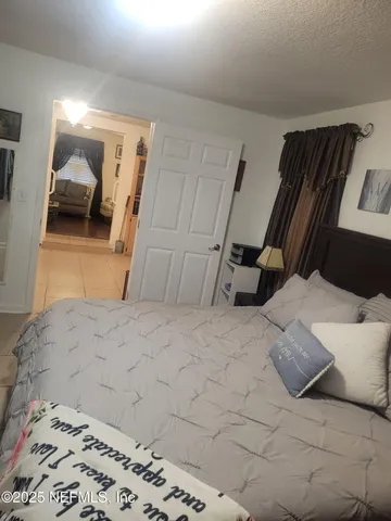 a bedroom with a bed and a mirror