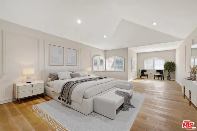 a spacious bedroom with a bed and a couch