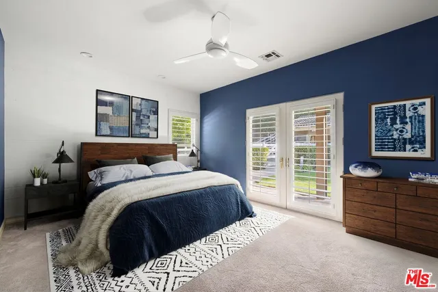 a bedroom with a large bed and a dresser