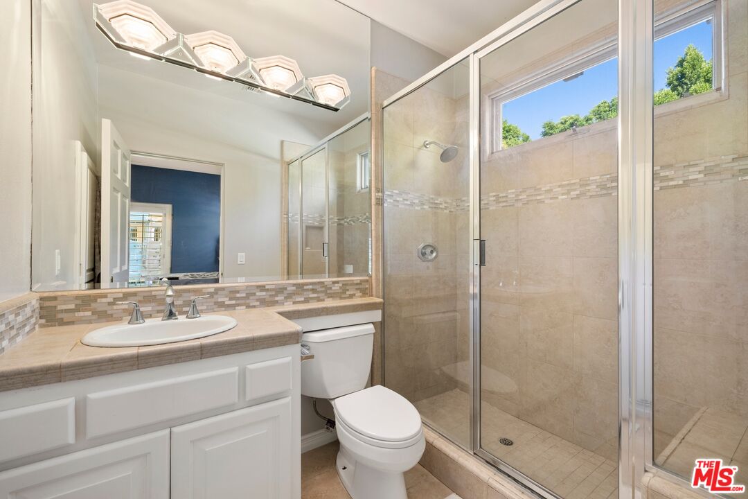 25217 Eldorado Meadow Road Hidden Hills, CA 91302 - Photo 14 of 28 a bathroom with a shower sink vanity mirror and toilet