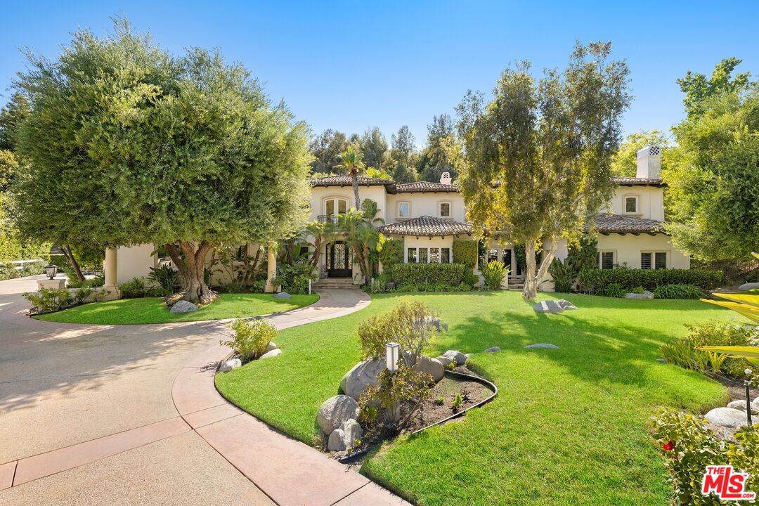 25217 Eldorado Meadow Road Hidden Hills, CA 91302 - Photo 19 of 28 a front view of a house with a yard and trees