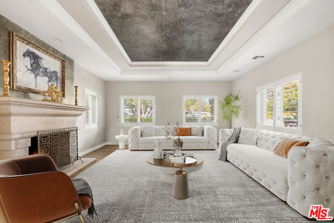 25217 Eldorado Meadow Road Hidden Hills, CA 91302 - Photo 2 of 28 a living room with furniture and a fireplace