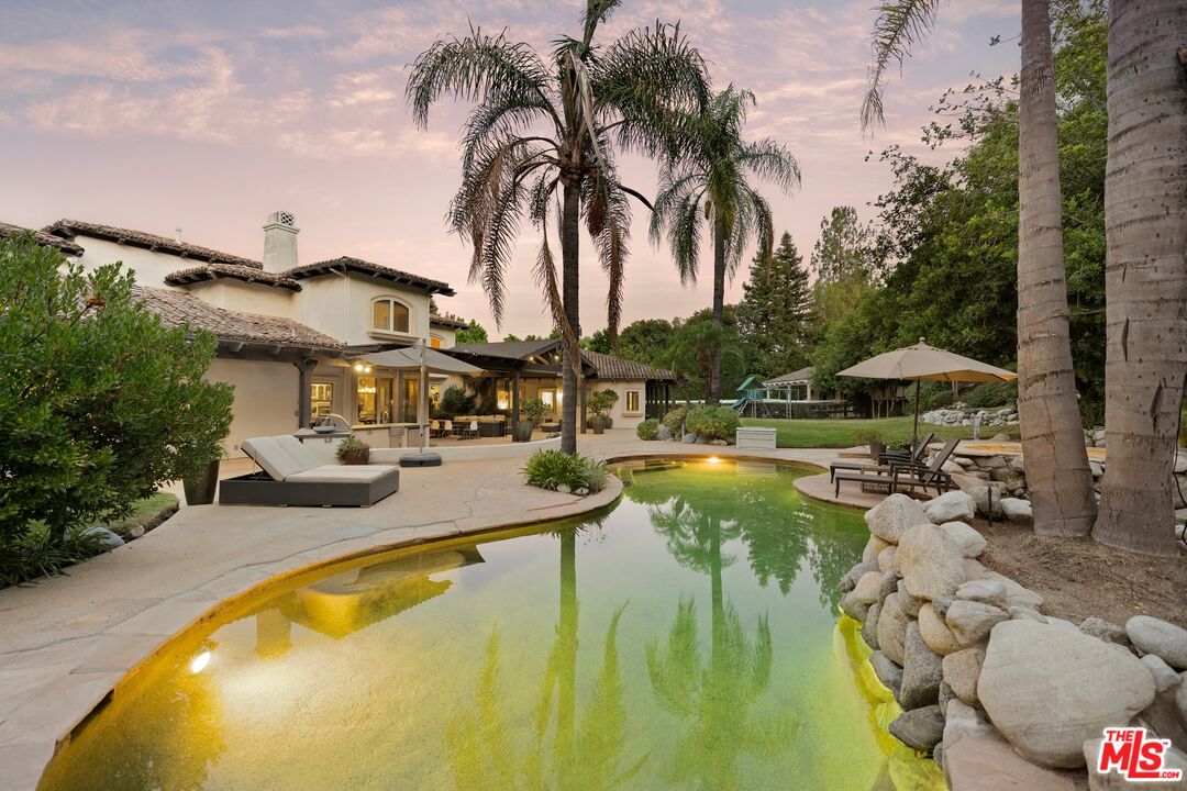 25217 Eldorado Meadow Road Hidden Hills, CA 91302 - Photo 22 of 28 a swimming pool with outdoor seating and yard