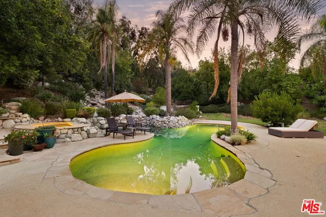 a view of a swimming pool with a patio