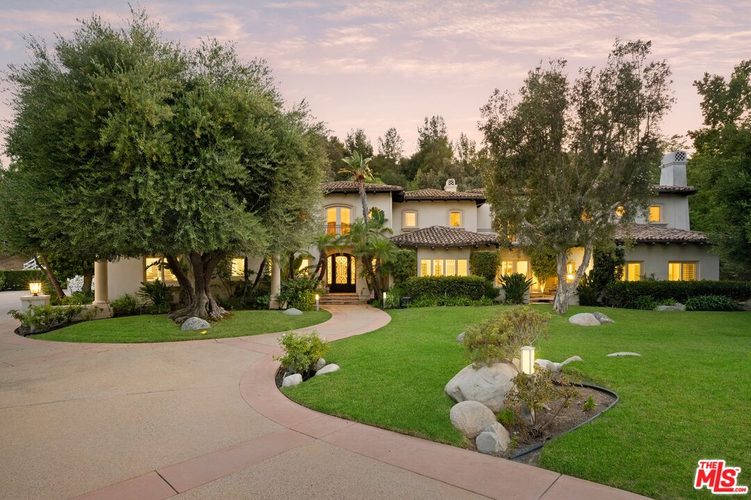 25217 Eldorado Meadow Road Hidden Hills, CA 91302 - Photo 27 of 28 a front view of a house with a yard and trees