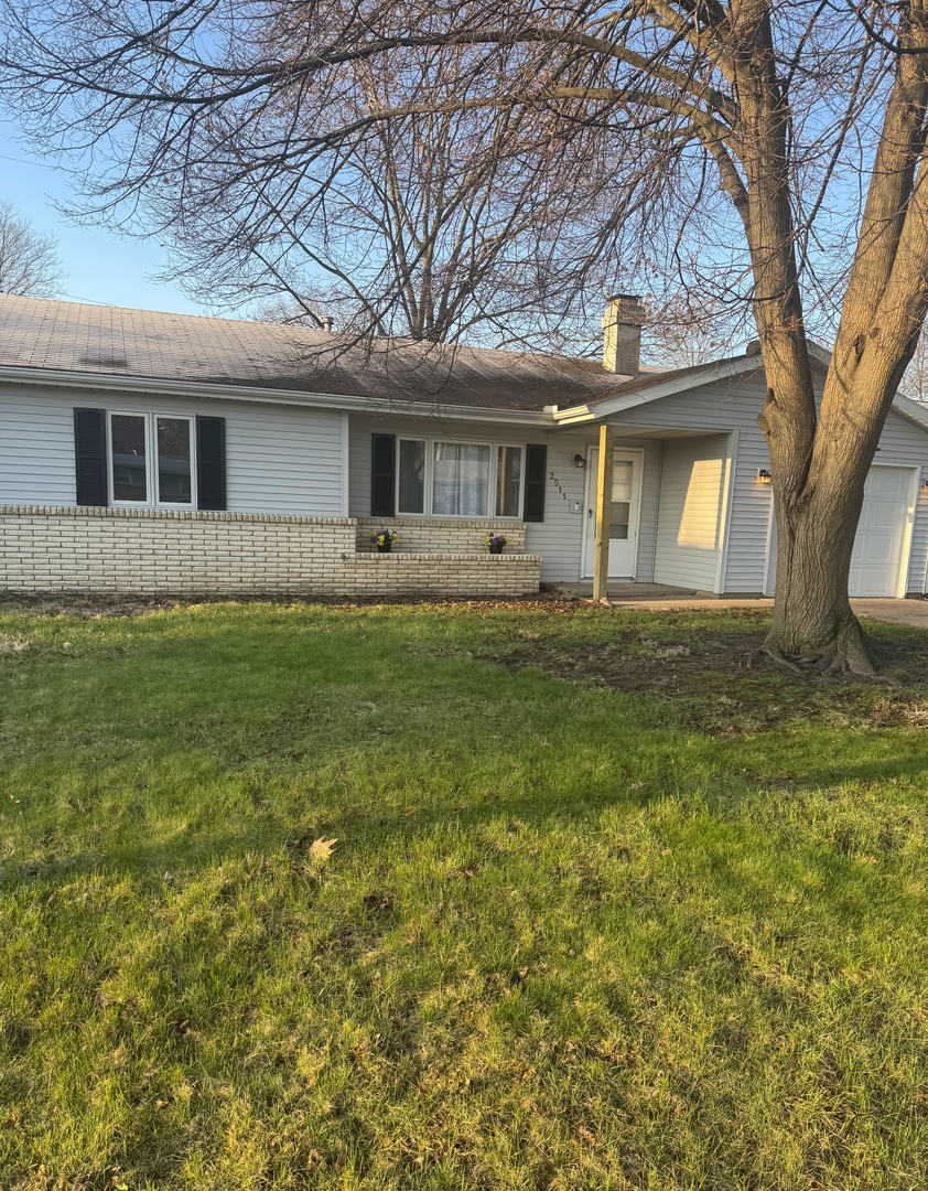 2511 Trafalgar Square Champaign, IL 61821 - Photo 1 of 26 a front view of a house with a garden and trees