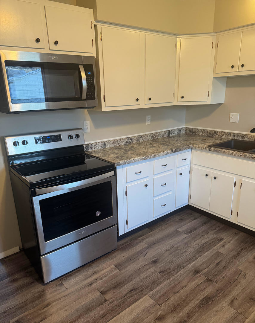 2511 Trafalgar Square Champaign, IL 61821 - Photo 12 of 26 a kitchen with granite countertop cabinets and steel stainless steel appliances