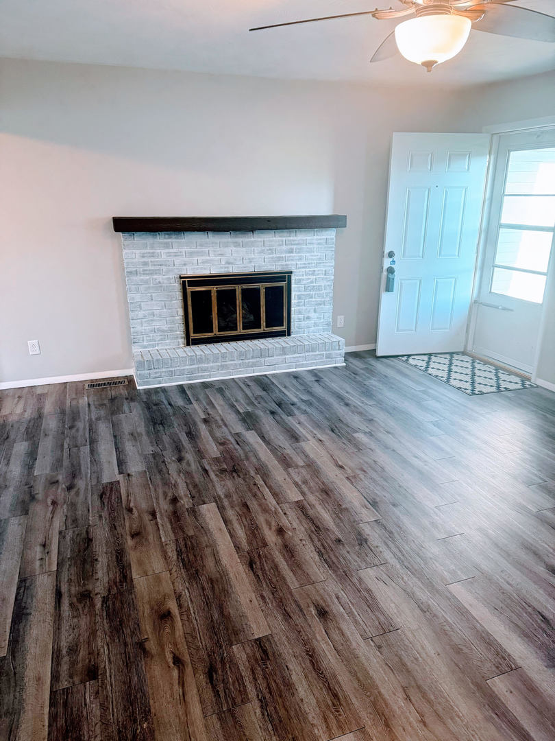 2511 Trafalgar Square Champaign, IL 61821 - Photo 6 of 26 wooden floor in an empty room with a fireplace