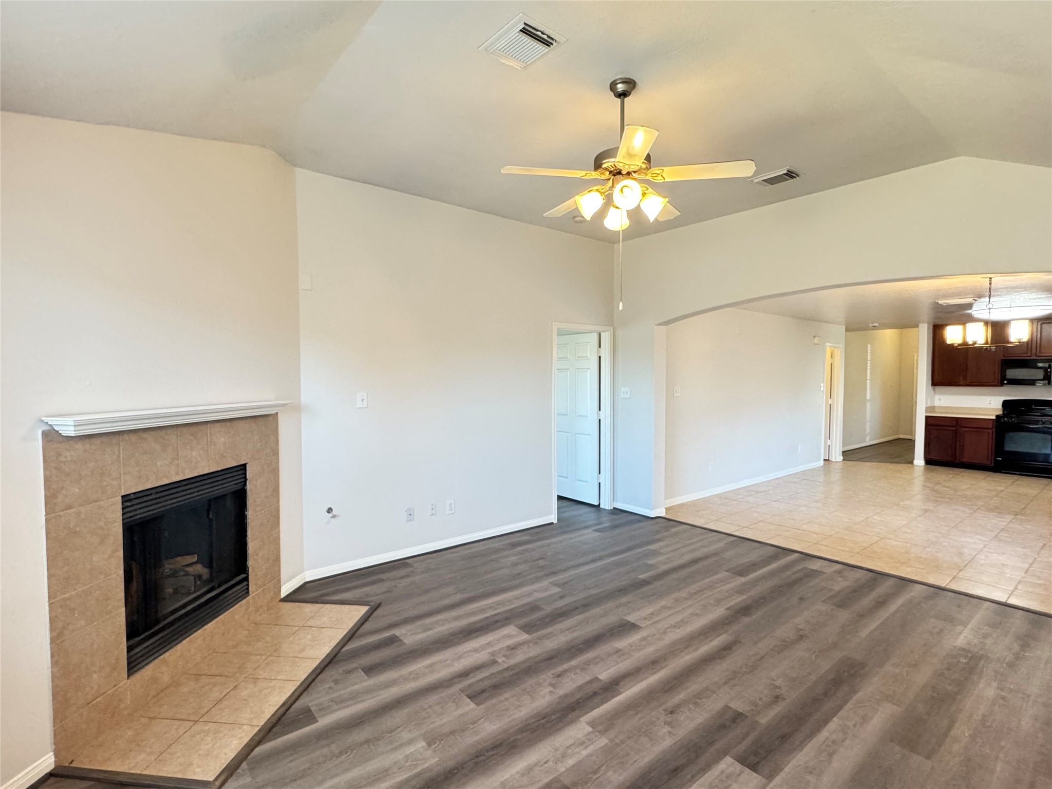 21543 Falvel Misty Drive Spring, TX 77388 - Photo 13 of 40 a view of empty room with a fireplace and chandelier fan