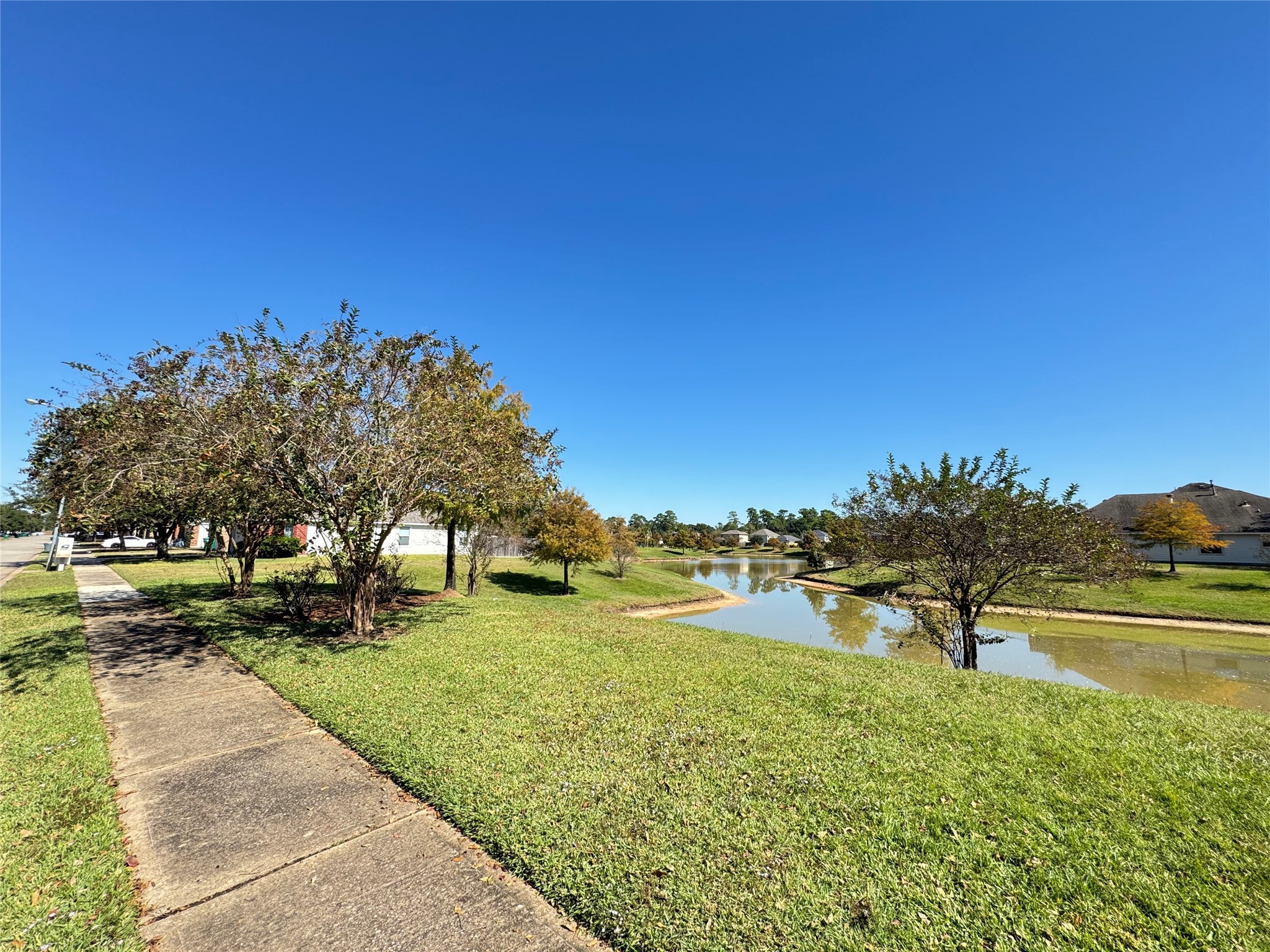 21543 Falvel Misty Drive Spring, TX 77388 - Photo 36 of 40 a view of a lake with a yard
