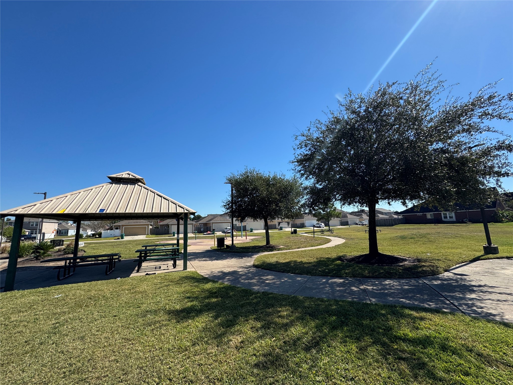 21543 Falvel Misty Drive Spring, TX 77388 - Photo 40 of 40 a view of a garden with a bench under an umbrella