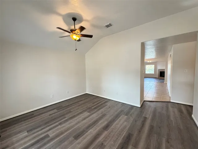 a large kitchen with stainless steel appliances granite countertop a refrigerator and a stove