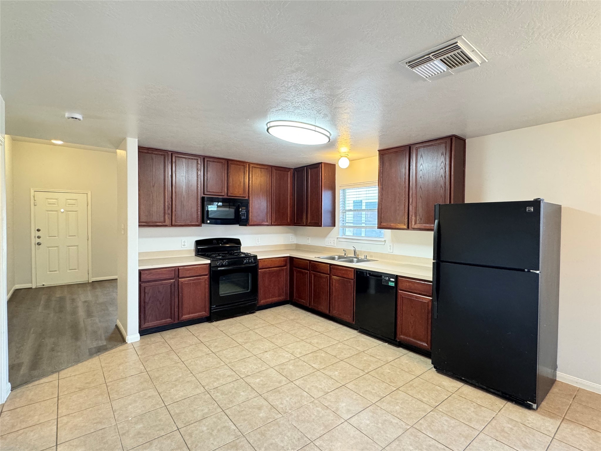 21543 Falvel Misty Drive Spring, TX 77388 - Photo 10 of 40 a large kitchen with stainless steel appliances granite countertop a refrigerator and a stove