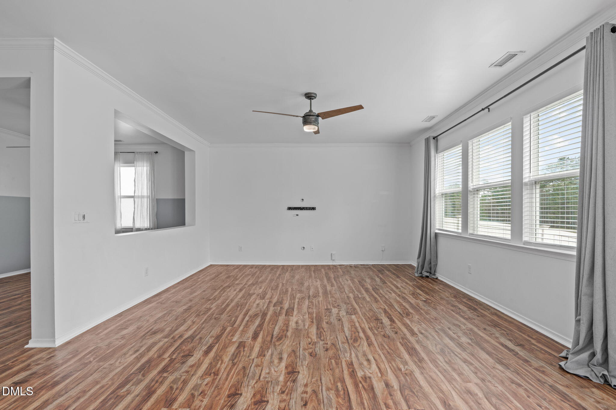 124 Daneborg Road Durham, NC 27703 - Photo 22 of 40 a view of empty room with wooden floor and fan