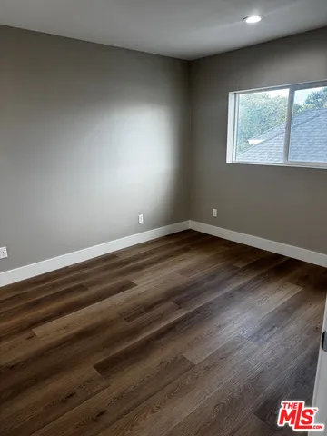 a bathroom with a granite countertop shower and a toilet