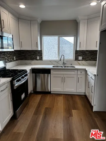 a view of kitchen and empty room