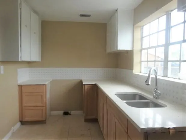 a kitchen with furniture and window