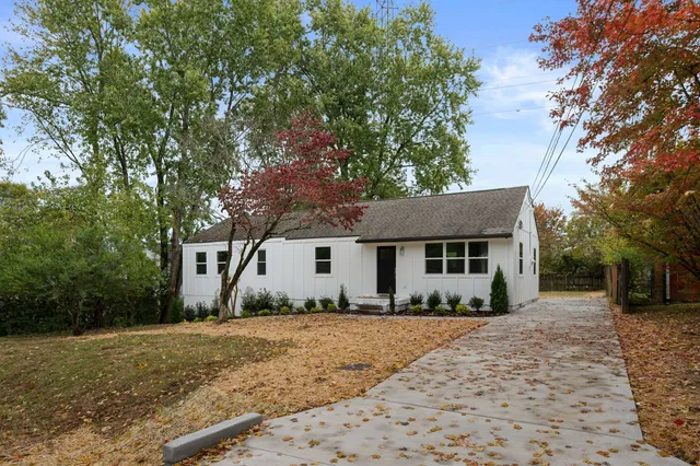 a front view of house with yard and trees around