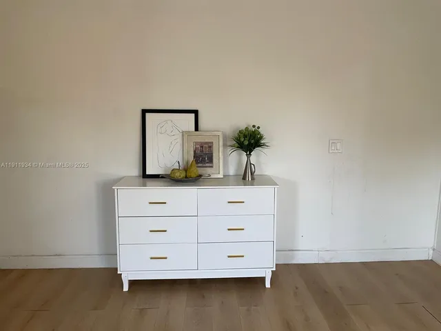a room with a dresser and a mirror