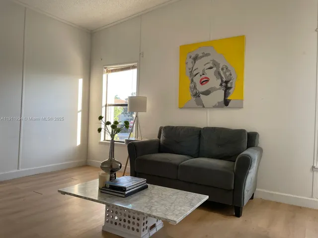 a living room with furniture and a potted plant