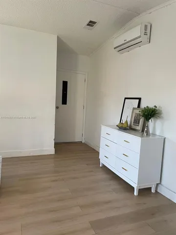 a room with furniture and wooden floor