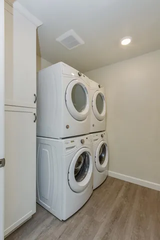 a kitchen with white cabinets and sink