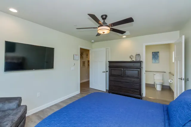 a bedroom with a large bed couch and a window