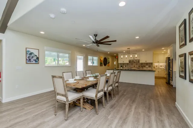 a view of a dining room with furniture and a kitchen