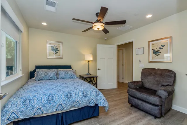a bedroom with a large bed and a flat screen tv