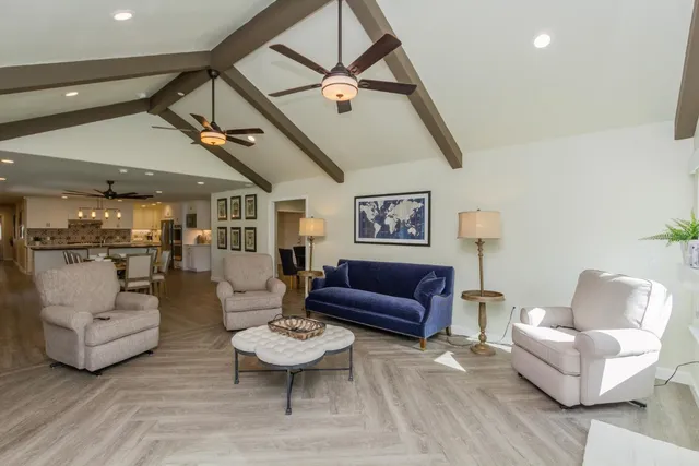 a living room with furniture and a ceiling fan