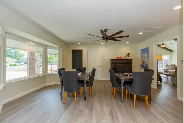 a dining room with wooden floor and a window