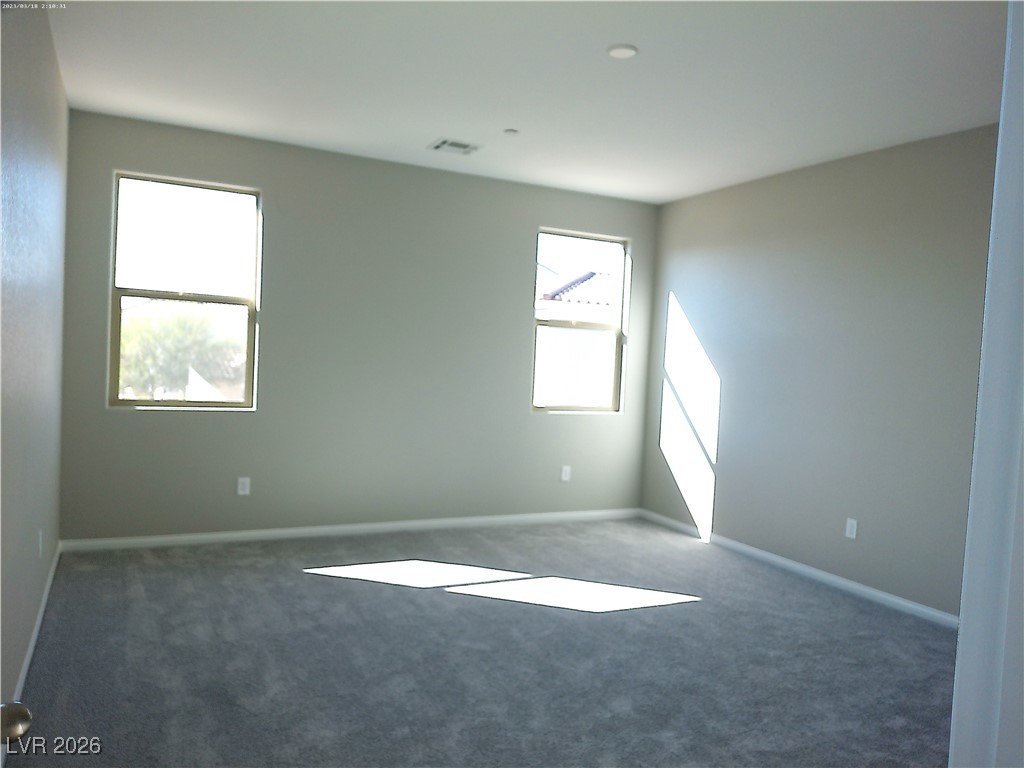 6607 Dove Point Place Las Vegas, NV 89130 - Photo 12 of 14 Empty room featuring dark carpet and baseboards