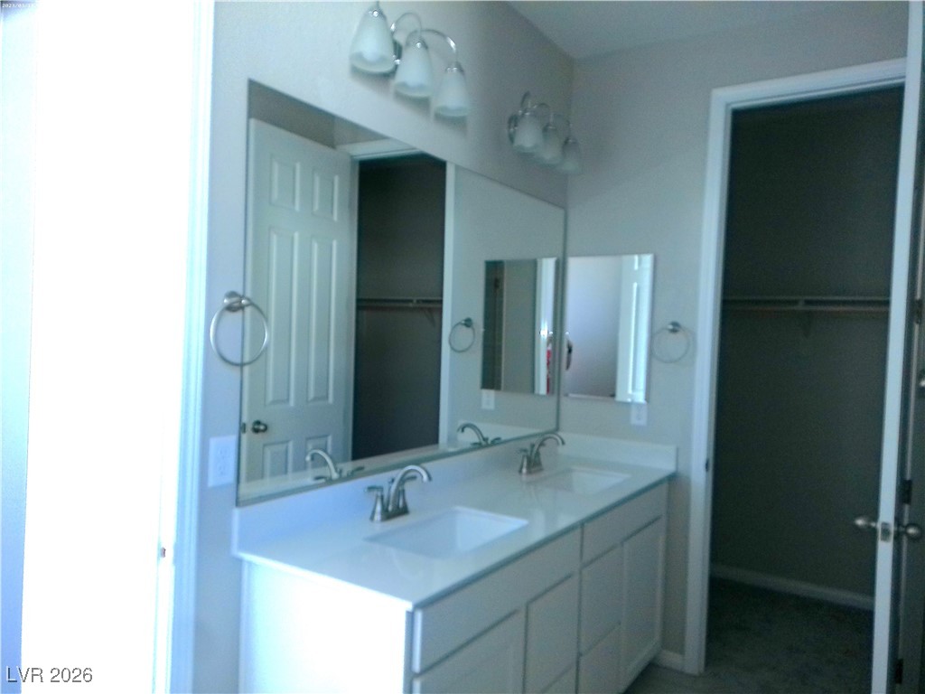 6607 Dove Point Place Las Vegas, NV 89130 - Photo 6 of 14 Full bathroom featuring a spacious closet and double vanity