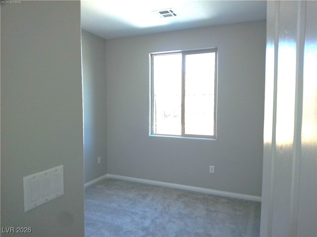 6607 Dove Point Place Las Vegas, NV 89130 - Photo 8 of 14 Carpeted empty room with baseboards