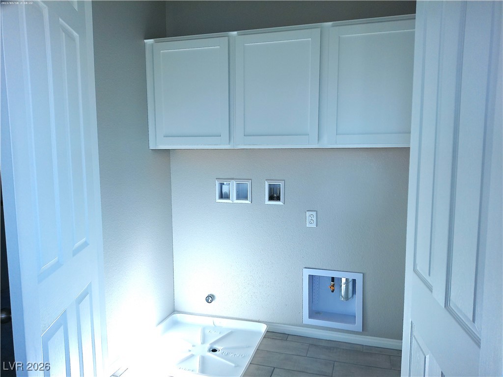 6607 Dove Point Place Las Vegas, NV 89130 - Photo 10 of 14 Laundry area with cabinet space and hookup for a washing machine